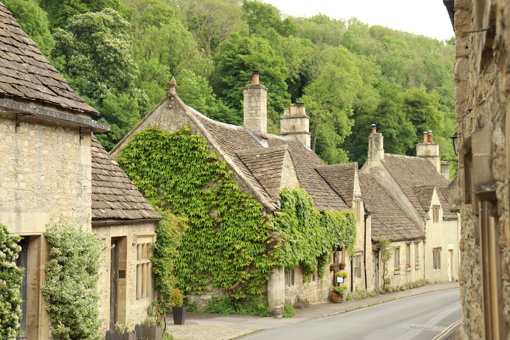 Heritage stone houses with ivy on a Cotswold street