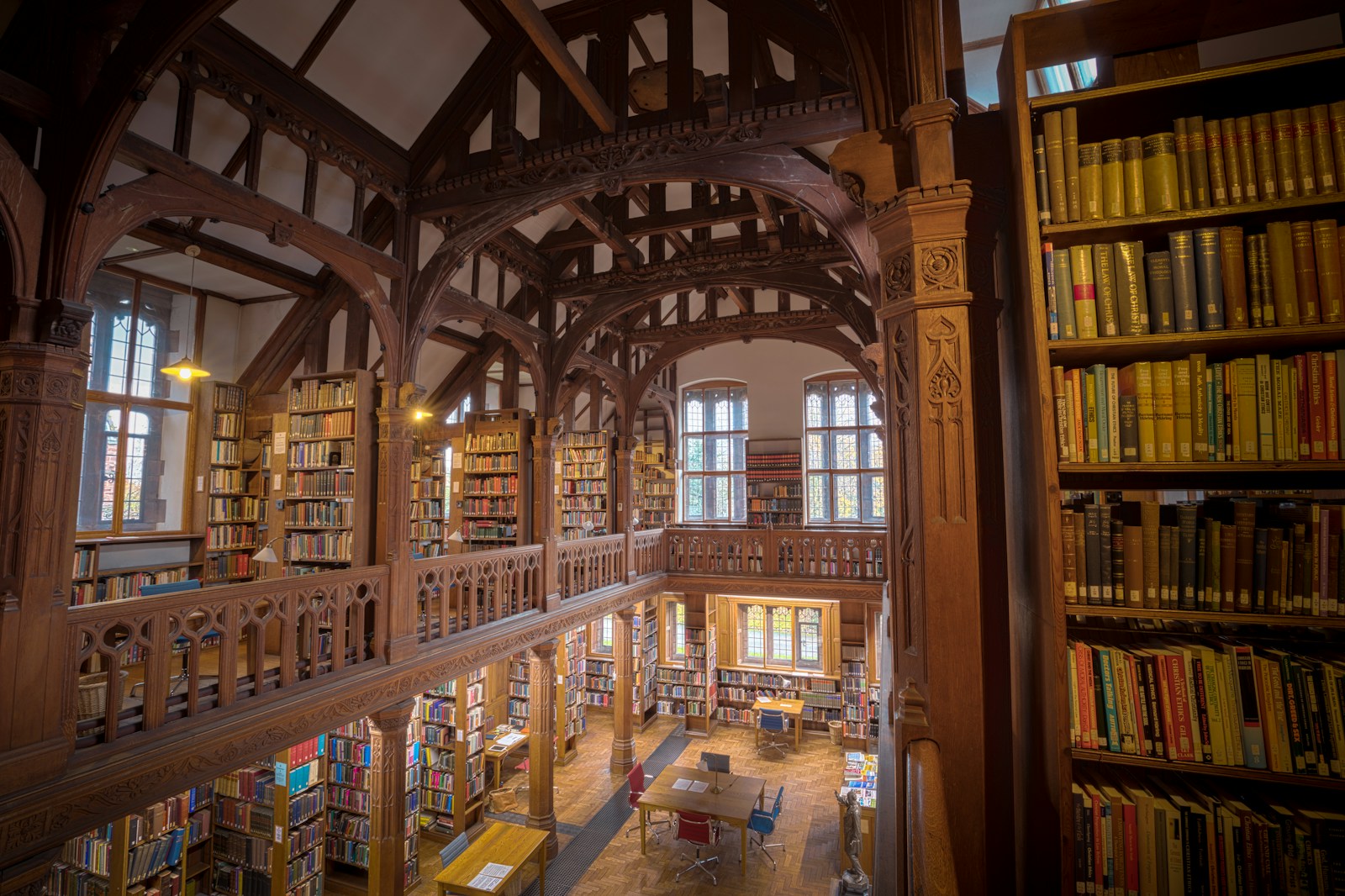 Grand library with wooden beams and rows of bookshelves
